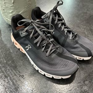 On running shoes.   Grey and pink